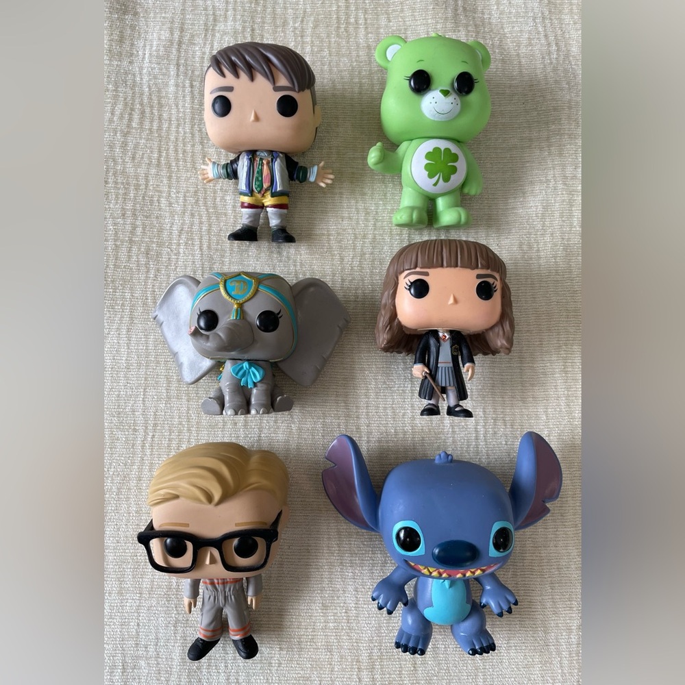 Funko Pop collectible figures: Dumbo, Carebear, Kevin, Joey, Hermione, Stitch.